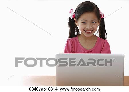 Young Chinese girl playing on laptop View Large Photo Image Picture - Young Chinese girl playing on laptop. Fotosearch