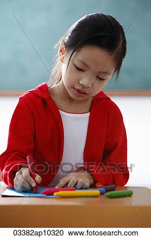 Young girl coloring with crayons View Large Photo Image Stock Image - Young girl coloring with crayons. Fotosearch