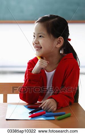Young girl holding crayon and smiling View Large Photo Image Stock Image - Young girl holding crayon and smiling. Fotosearch