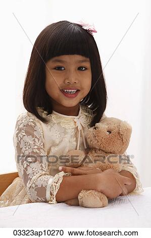 young girl holding teddy bear and smiling View Large Photo Image Stock Image - young girl holding teddy bear and smiling. Fotosearch