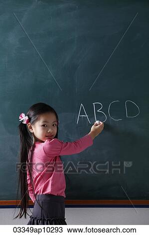 young girl writing on chalk board View Large Photo Image Stock Image - young girl writing on chalk board. Fotosearch