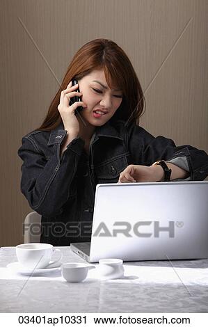 Young woman talking on phone, looking at watch and making a face. View Large Photo Image Stock Image - Young woman talking on phone, looking at watch and making a face.. Fotosearch