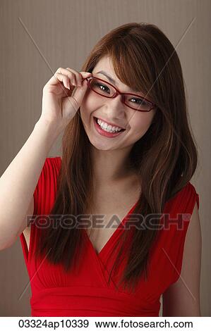 Young woman wearing red dress and red glasses View Large Photo Image Stock Photo - Young woman wearing red dress and red glasses. Fotosearch