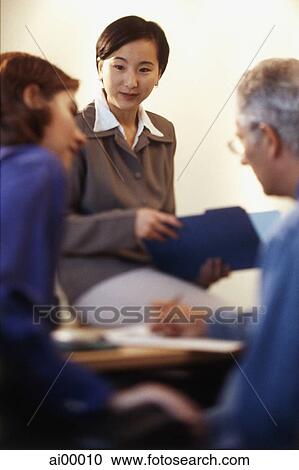 Asian female executive in meeting with two Caucasian executives View Large Photo Image Stock Image - Asian female executive in meeting with two Caucasian executives. Fotosearch