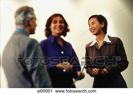 Asian female executive talking with two Caucasian executives View Large Photo Image Stock Image - Asian female executive talking with two Caucasian executives. Fotosearch