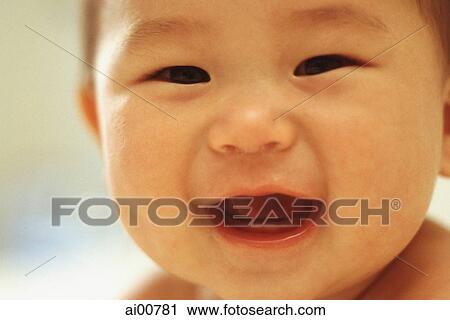 Stock Image - Baby boy (3 - 9 months old), laughing, close up. Fotosearch