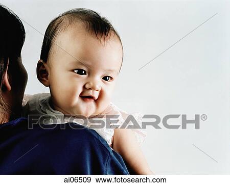 Baby girl, 3 to 6 months, looking over mother's shoulder View Large Photo Image Stock Photo - Baby girl, 3 to 6 months, looking over mother's shoulder. Fotosearch