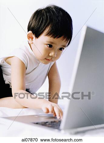 Boy, 3 years old, using laptop. View Large Photo Image Stock Image - Boy, 3 years old, using laptop.. Fotosearch
