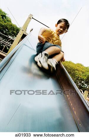 Boy going down slide View Large Photo Image Stock Image - Boy going down slide. Fotosearch