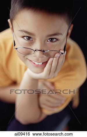 Boy smiling, hand on chin View Large Photo Image Stock Photograph - Boy smiling, hand on chin. Fotosearch