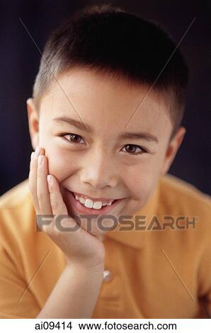 Picture - Boy with hand on chin. Fotosearch