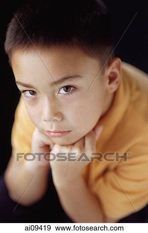 Boy with hand on chin View Large Photo Image Stock Photo - Boy with hand on chin. Fotosearch