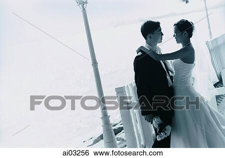 Bride and groom embracing View Large Photo Image Stock Photograph - Bride and groom embracing. Fotosearch