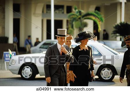 Stock Image - Brunei, A British diplomat and his wife arrive for a birthday celebration honoring Sultan Hassanal Bolkiah of Brunei.. Fotosearch