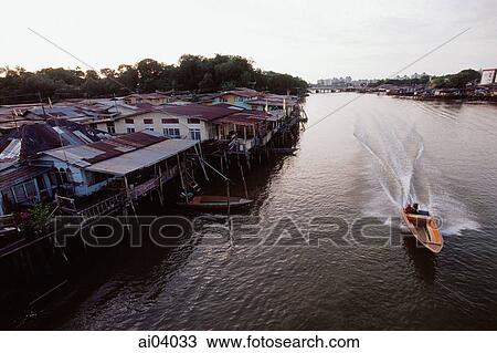 Stock Image - Brunei Darussalam, Borneo, A boat speeds along the river.. Fotosearch