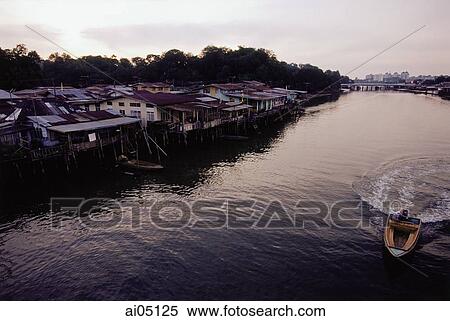Stock Photography - Brunei Darussalam, Borneo, A boat speeding along the river.. Fotosearch