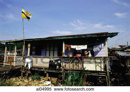Stock Photography - Brunei, Kampong Ayer, A typical home flies the Brunei flag.. Fotosearch
