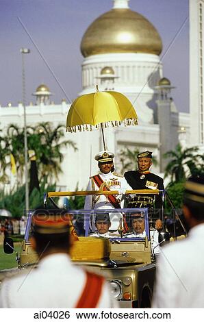 Brunei, Sultan Hassanal Bolkiah watches a military ceremony in honor of his birthday from a reviewing stand. View Large Photo Image Stock Photograph - Brunei, Sultan Hassanal Bolkiah watches a military ceremony in honor of his birthday from a reviewing stand.. Fotosearch