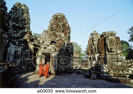 Cambodia, Angkor Thom, monks walking between face towers of the Bayon View Large Photo Image Stock Image - Cambodia, Angkor Thom, monks walking between face towers of the Bayon. Fotosearch