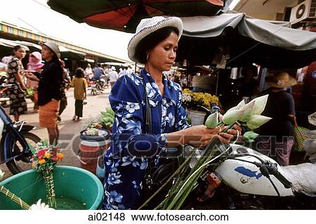 Cambodia, Phnom Penh, Cambodian woman buys flowers in market. View Large Photo Image Stock Photo - Cambodia, Phnom Penh, Cambodian woman buys flowers in market.. Fotosearch