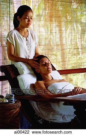 Caucasian female receiving a head massage from Asian masseuse View Large Photo Image Stock Image - Caucasian female receiving a head massage from Asian masseuse. Fotosearch