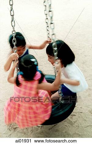 Children playing on a tire swing View Large Photo Image Stock Image - Children playing on a tire swing. Fotosearch
