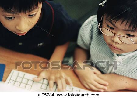 Children using computer, elevated view ( high grain) View Large Photo Image Picture - Children using computer, elevated view ( high grain). Fotosearch