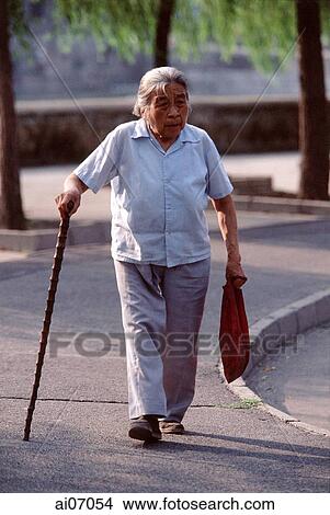 China, Beijing, old woman walking with cane View Large Photo Image Picture - China, Beijing, old woman walking with cane. Fotosearch