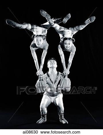 China, Hong Kong, Acrobats of the Shenyang Acrobatic Troupe performing balancing act with bowls View Large Photo Image Stock Image - China, Hong Kong, Acrobats of the Shenyang Acrobatic Troupe performing balancing act with bowls. Fotosearch