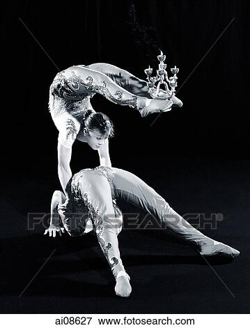China, Hong Kong, Acrobats of the Shenyang Acrobatic Troupe balancing with candle holder View Large Photo Image Stock Photo - China, Hong Kong, Acrobats of the Shenyang Acrobatic Troupe balancing with candle holder. Fotosearch
