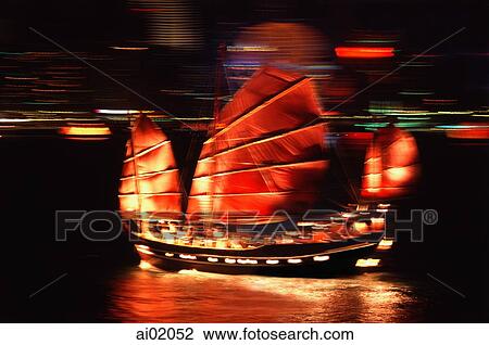Stock Image - China, Hong Kong, Chinese Junk in Hong Kong Harbor at night. Fotosearch