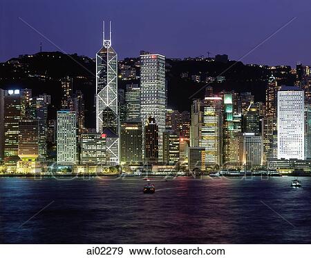 Stock Photo - China, Hong Kong skyline, view from across harbor, night view. Fotosearch