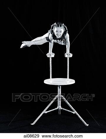 China, Hong Kong, Youngest acrobat of the Shenyang Acrobatic Troupe balancing on both hands View Large Photo Image Stock Photo - China, Hong Kong, Youngest acrobat of the Shenyang Acrobatic Troupe balancing on both hands. Fotosearch