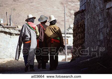 Picture - China, Szechuan (Sichuan), Kham region, Khampa men walking through village.. Fotosearch