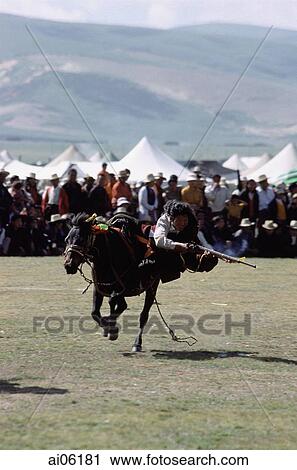 China, Szechuan (Sichuan), Kham region, Skilled horseman in traditional costume shooting from horse with musket during summer nomad festival. View Large Photo Image Stock Image - China, Szechuan (Sichuan), Kham region, Skilled horseman in traditional costume shooting from horse with musket during summer nomad festival.. Fotosearch