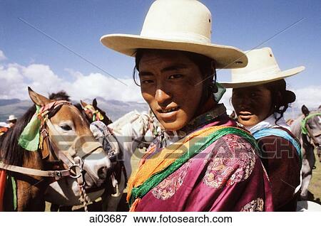 China, Szechuan (Sichuan), Kham region, A Khampa man and woman stand with horses at the summer nomad festival. View Large Photo Image Stock Photo - China, Szechuan (Sichuan), Kham region, A Khampa man and woman stand with horses at the summer nomad festival.. Fotosearch