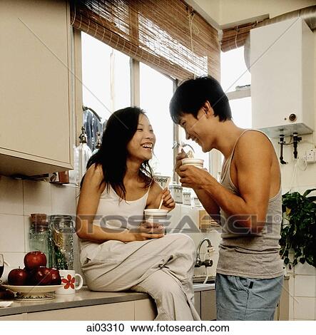 Couple eating instant noodles in kitchen View Large Photo Image Stock Image - Couple eating instant noodles in kitchen. Fotosearch