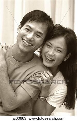 Couple embracing, laughing View Large Photo Image Stock Image - Couple embracing, laughing. Fotosearch