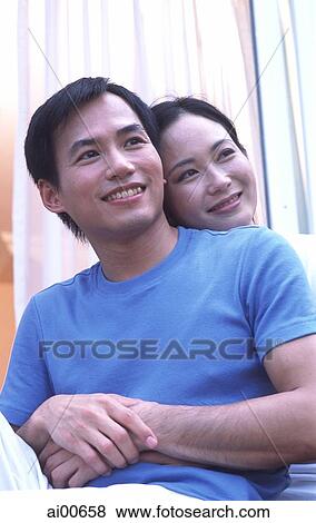 Couple embracing, sitting outdoors View Large Photo Image Stock Photo - Couple embracing, sitting outdoors. Fotosearch