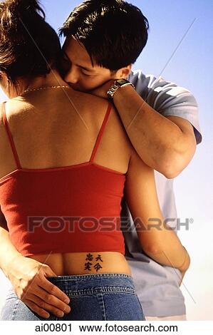 Couple embracing, woman with tattoo of Chinese characters on waist View Large Photo Image Stock Image - Couple embracing, woman with tattoo of Chinese characters on waist. Fotosearch