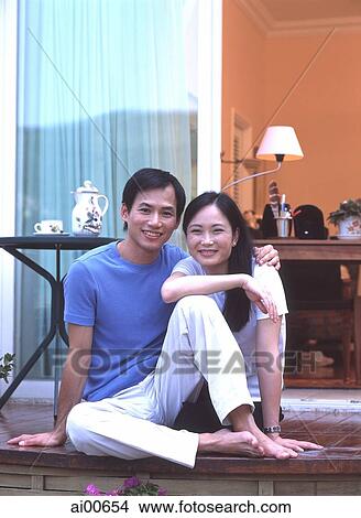 Couple sitting outdoors on balcony View Large Photo Image Picture - Couple sitting outdoors on balcony. Fotosearch