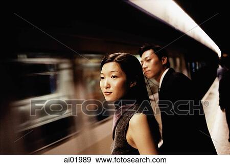 Couple walking, woman holding man's arm, smiling at each other View Large Photo Image Stock Photo - Couple walking, woman holding man's arm, smiling at each other. Fotosearch