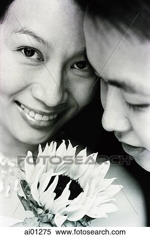 Couple with flower, smiling, portrait View Large Photo Image Stock Photography - Couple with flower, smiling, portrait. Fotosearch