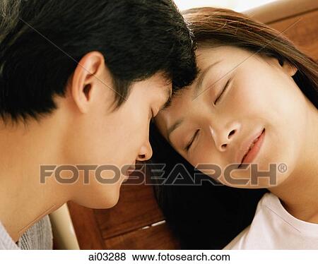 Couple with heads together, eyes closed View Large Photo Image Stock Photo - Couple with heads together, eyes closed. Fotosearch