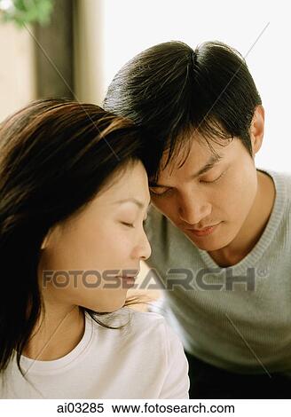 Couple with heads together, eyes closed View Large Photo Image Stock Photography - Couple with heads together, eyes closed. Fotosearch
