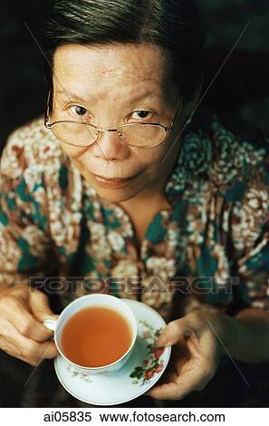 Elderly lady holding teacup and saucer, portrait View Large Photo Image Stock Photography - Elderly lady holding teacup and saucer, portrait. Fotosearch
