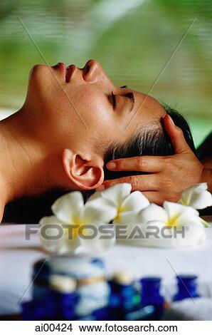 Eurasian female lying down receiving a head massage, profile View Large Photo Image Picture - Eurasian female lying down receiving a head massage, profile. Fotosearch
