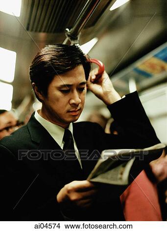 Executive in train reading newspaper. View Large Photo Image Picture - Executive in train reading newspaper.. Fotosearch