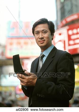 Executive man using PDA in street, portrait. View Large Photo Image Stock Photograph - Executive man using PDA in street, portrait.. Fotosearch