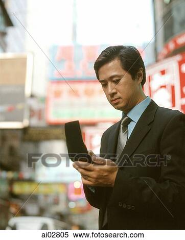 Executive man using PDA in street. View Large Photo Image Stock Photography - Executive man using PDA in street.. Fotosearch